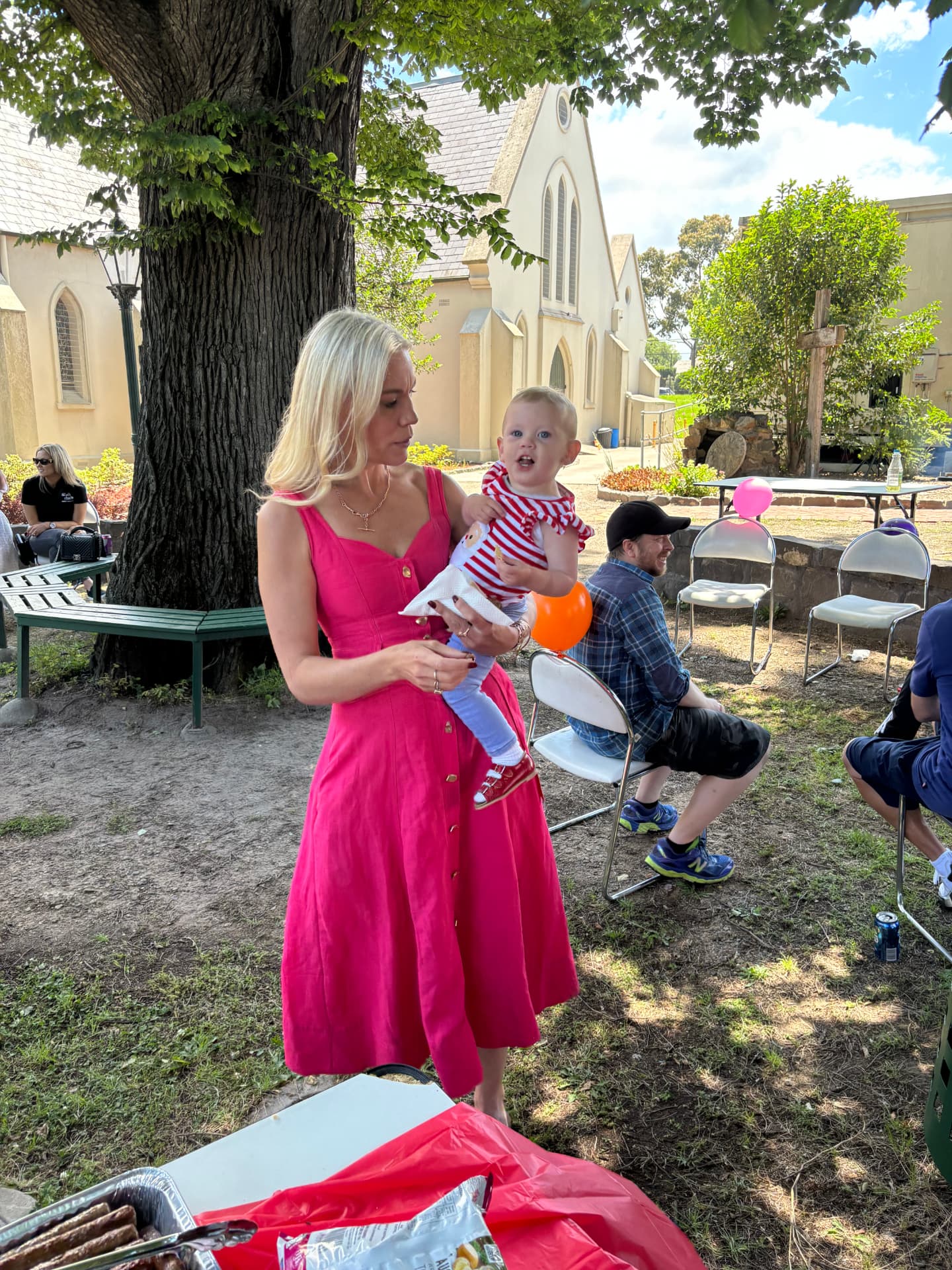 A mum and her baby at a Brigade family BBQ in the parish grounds