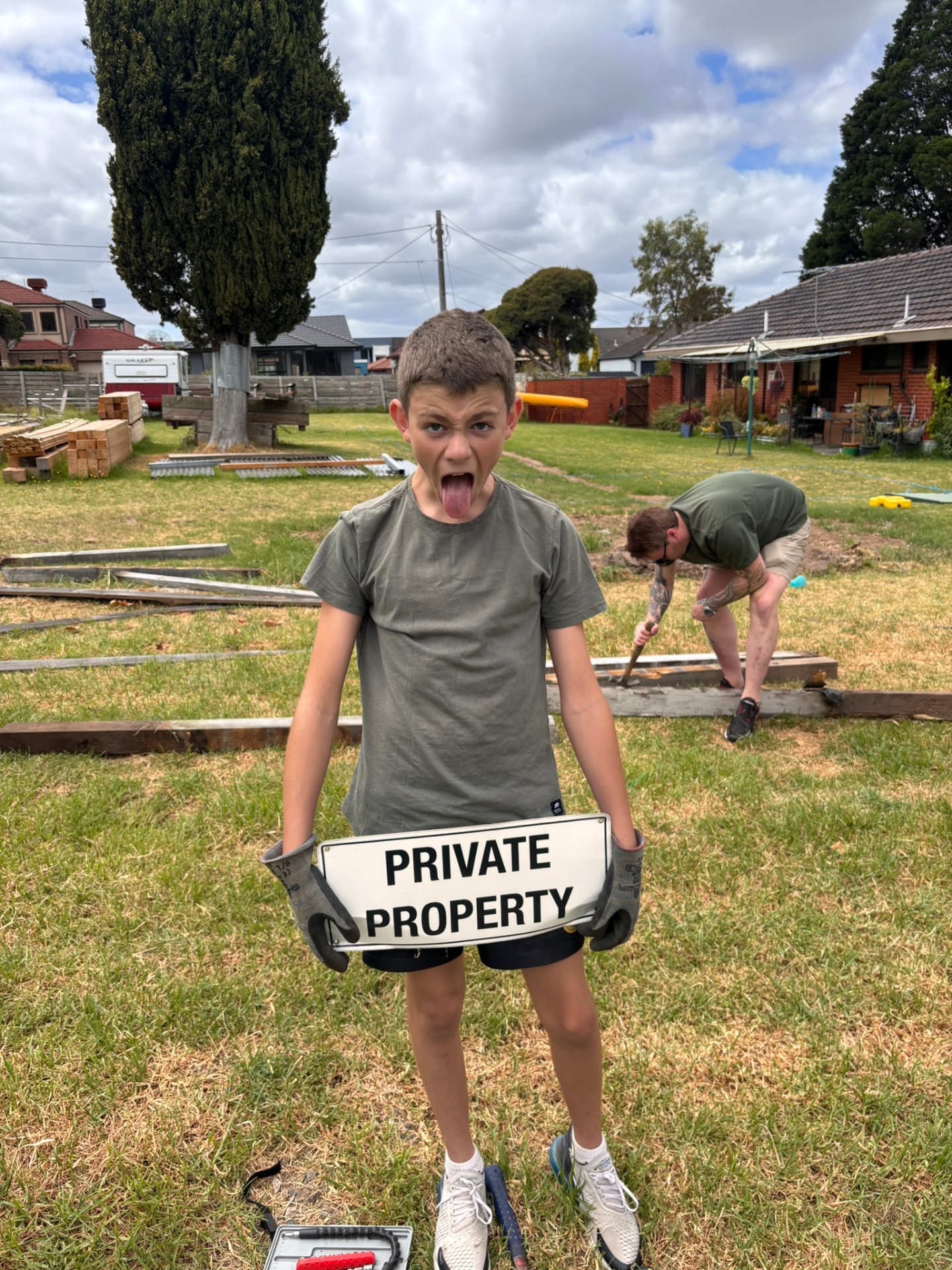 Younger volunteer mucking around at a backyard clean-up day