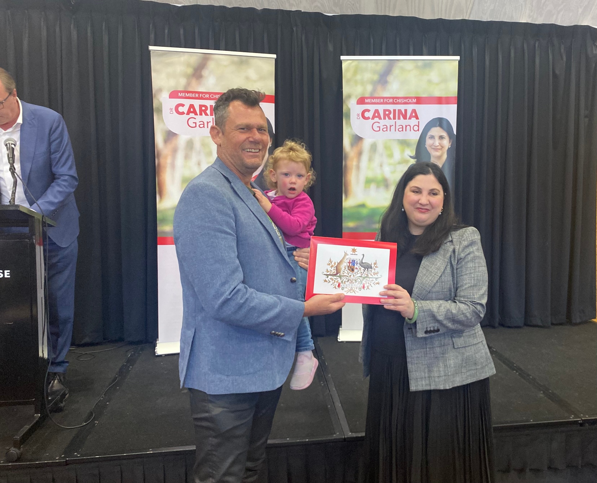 Stu and daughter receiving a federal recognition certificate from Dr Carina Garland MP